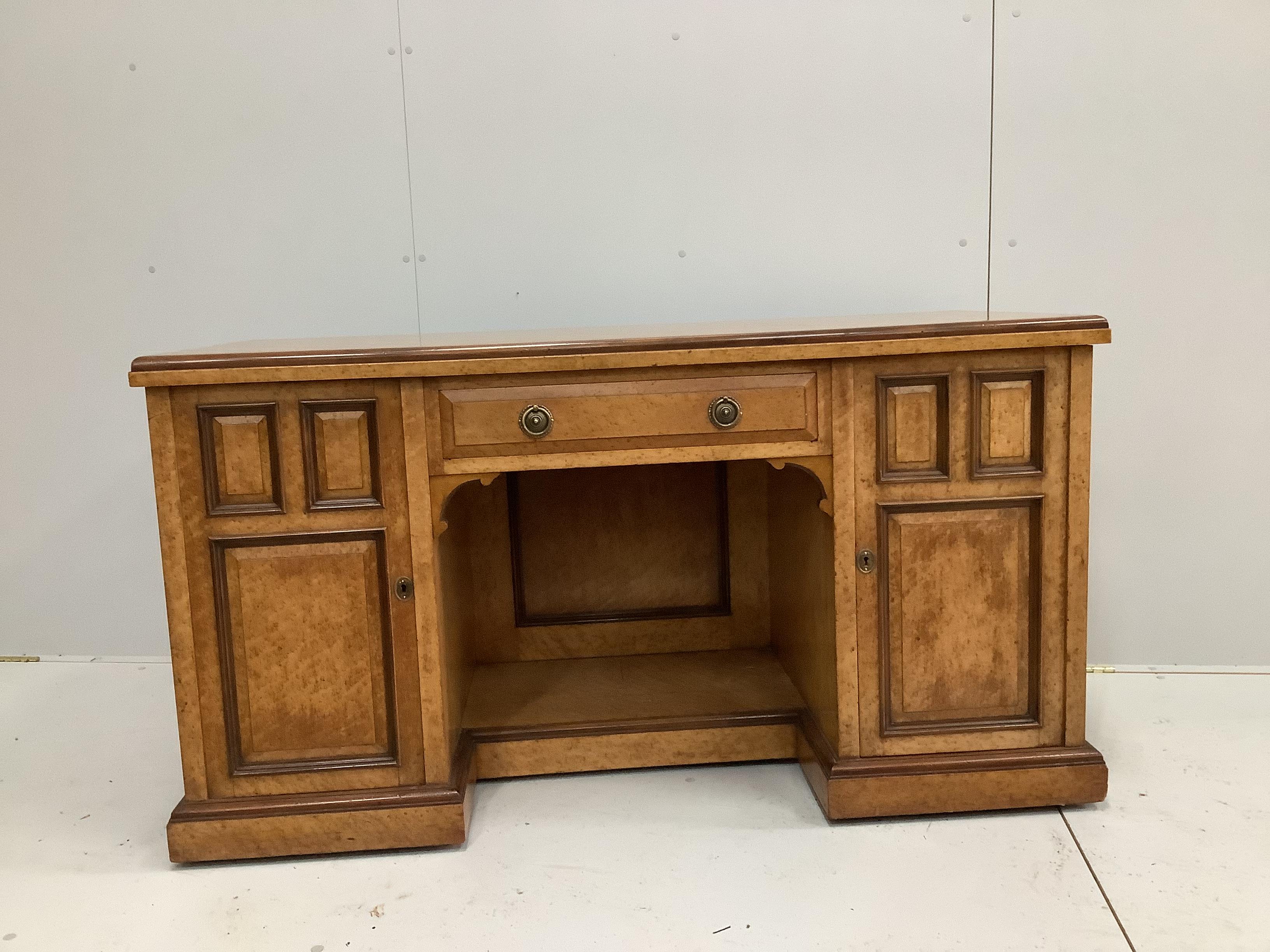 A late Victorian bird's eye maple kneehole desk by Moore and Hunton, London, width 140cm, depth 60cm, height 76cm